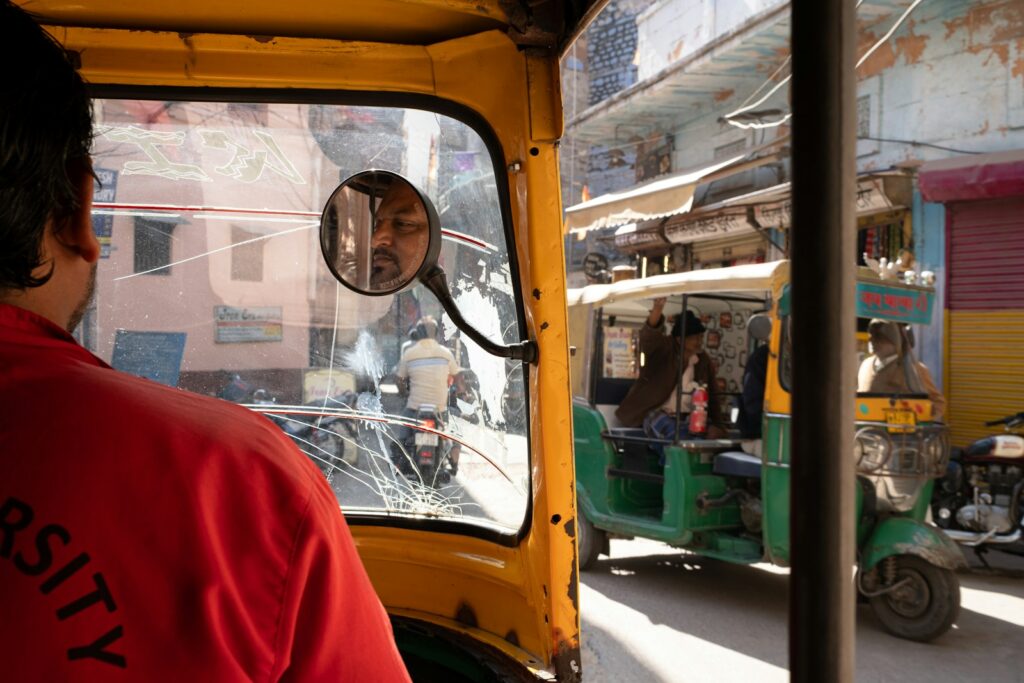 Inside an auto rickshaw, looking at the outside world.